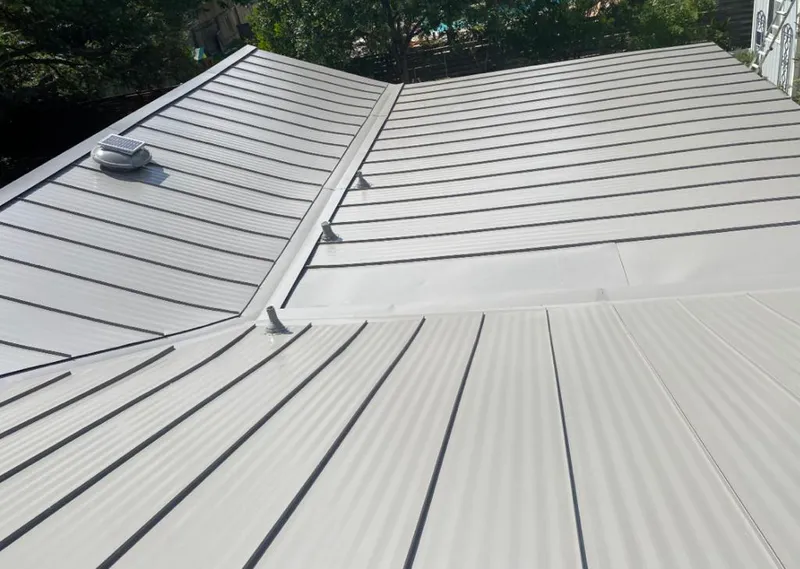 Solar attic fan installed on a metal roof for Roof Ventilation in Poulsbo